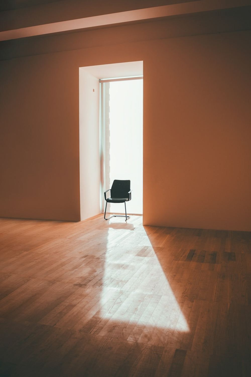 Warm light through an open doorway into an empty room