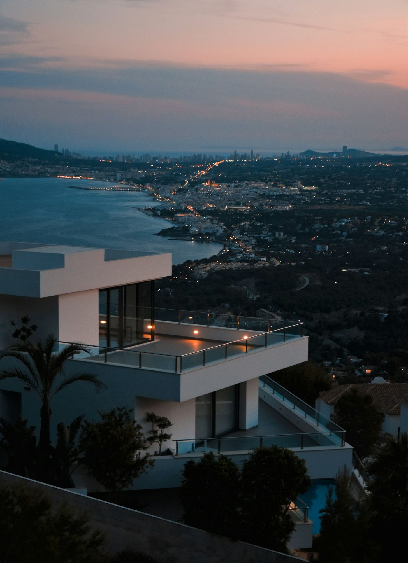 A white villa above the coast at dusk