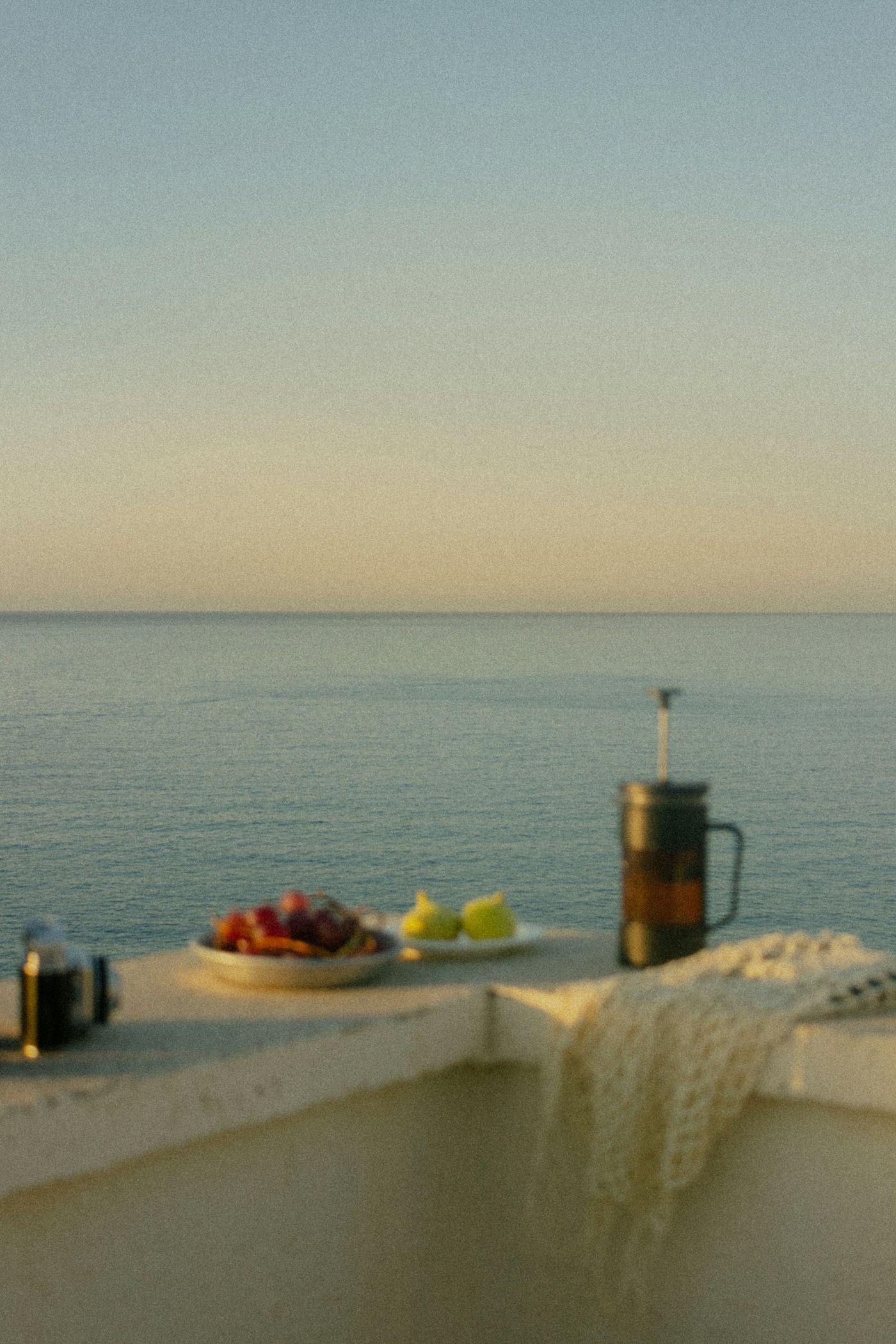 A breakfast table on a terrace above the sea