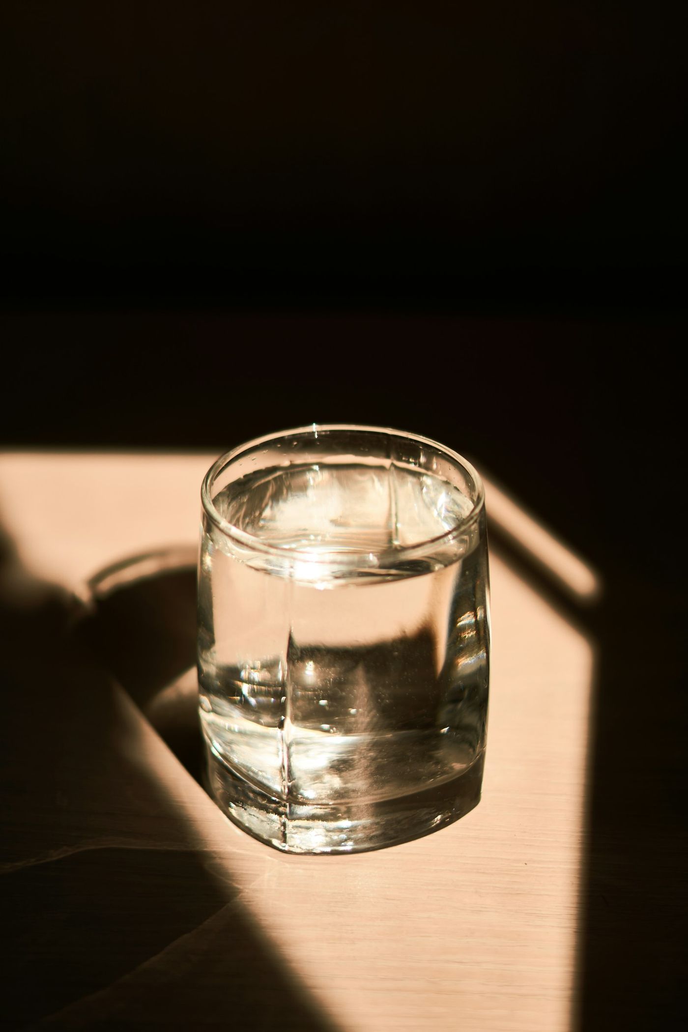 A glass of water in warm evening sunlight
